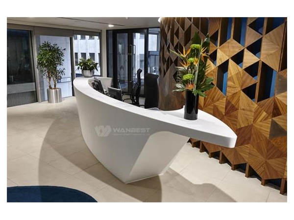Why does the reception desk choose artificial stone?